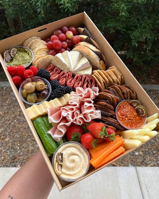 Medium grazing box with prosciutto, brie, olives, strawberries, dips and crackers