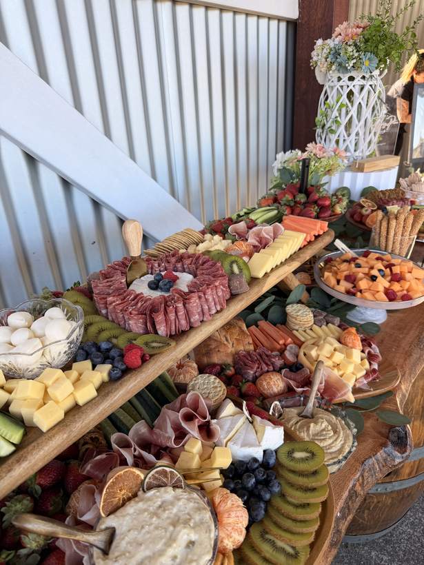 Grazing table on timber boards with wine barrels
