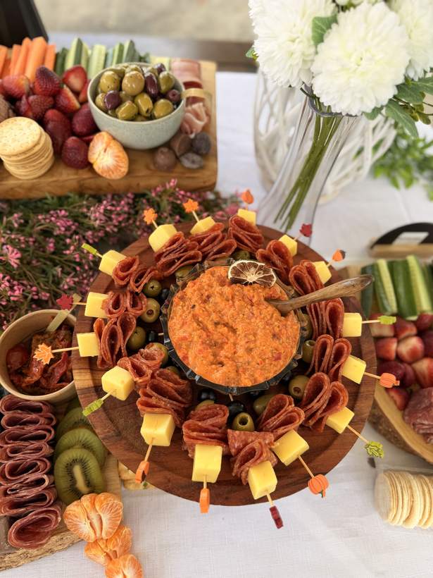 Salami and cheese skewers ringed around a bowl of dip