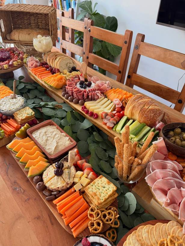 Long grazing table lined with eucalyptus leaves
