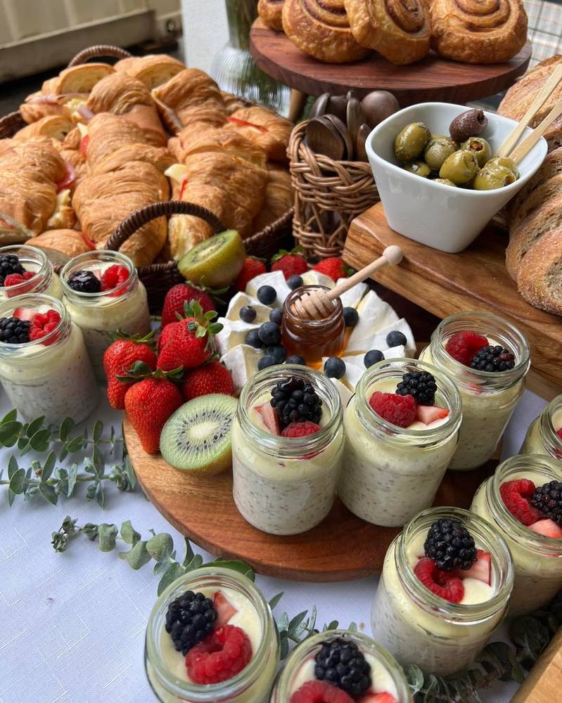 Brunch grazing with yoghurt jars, berries, brie, honey and croissants